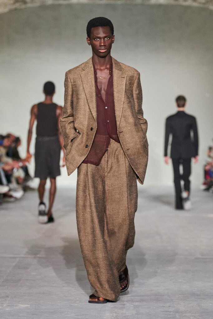 A relaxed brown cotton suit with a long-sleeve collared shirt and wide-leg trousers.