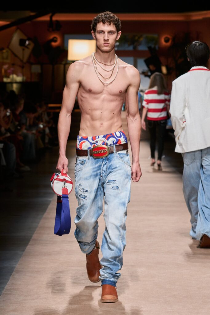 A pair of relaxed blue denim pants with a distressed finish.