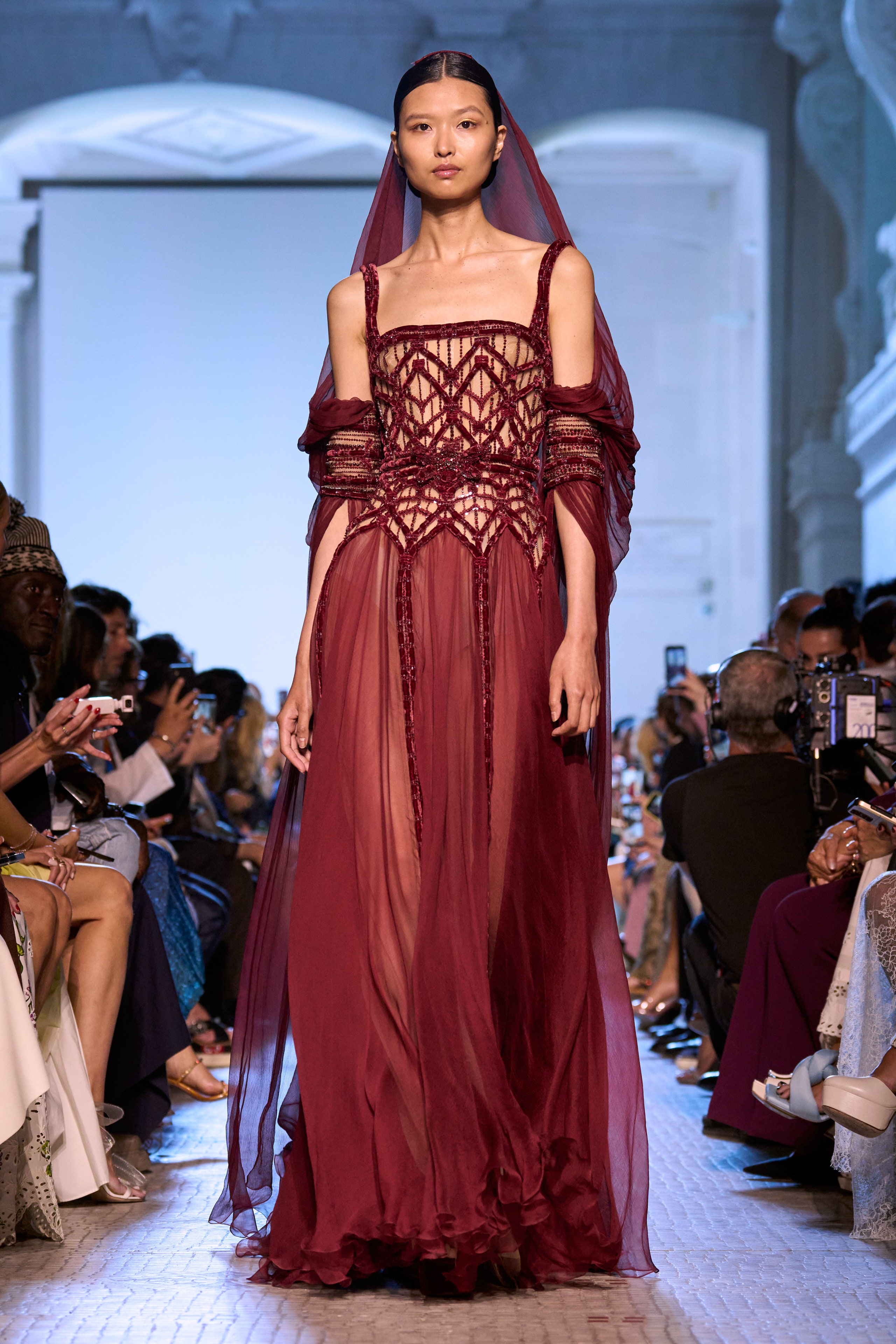 A relaxed burgundy silk sleeveless dress with a V-neckline and tiered design.