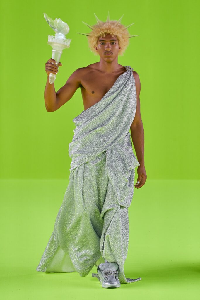 A relaxed silver metallic sleeveless dress with a draped design.