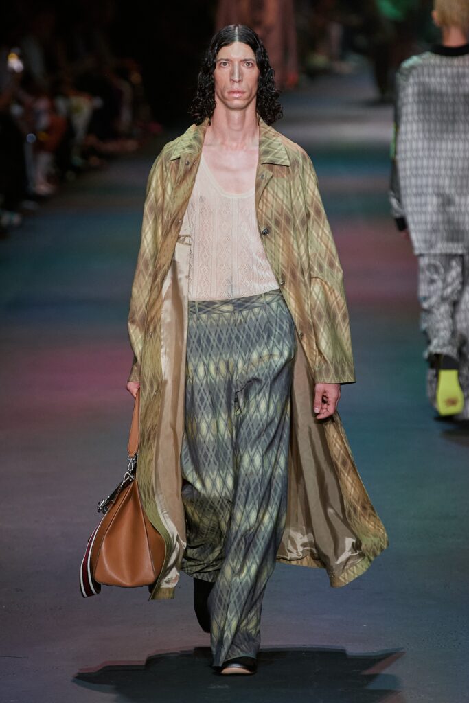 A relaxed-fit brown and green printed coat paired with wide-leg pants.