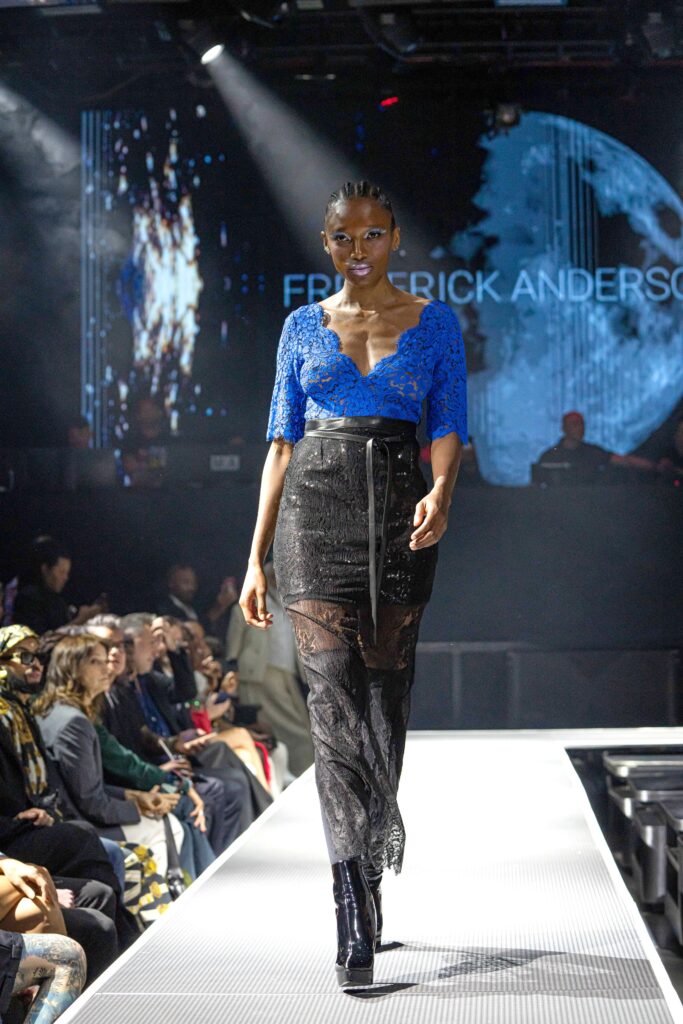 A fitted black lace dress with short sleeves and a V-neckline featuring an asymmetric design.