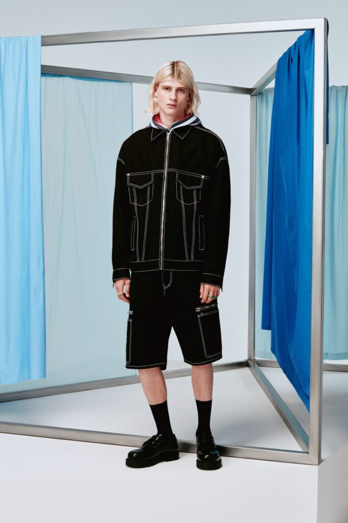 A relaxed black denim jacket with a collared neckline paired with matching shorts.