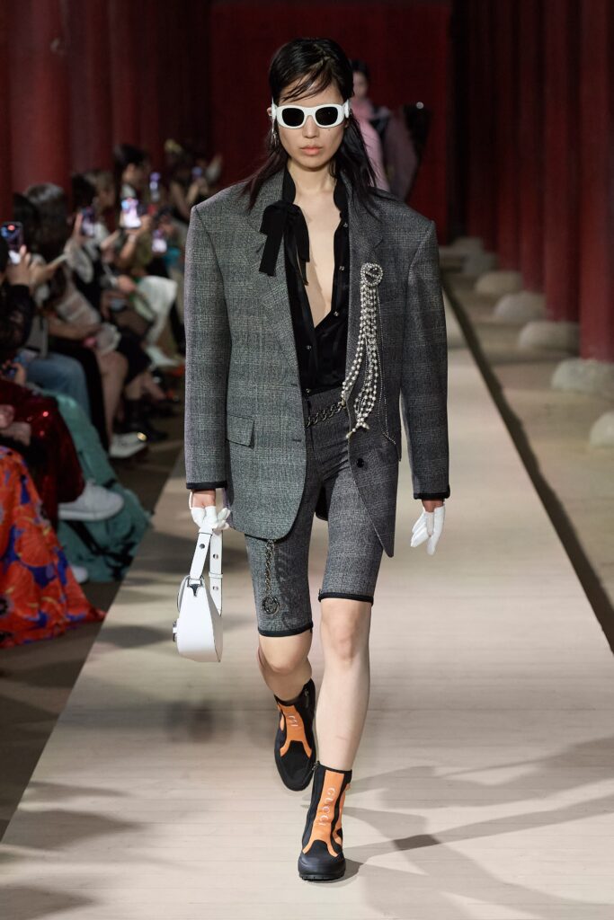 gray tailored blazer with black shorts