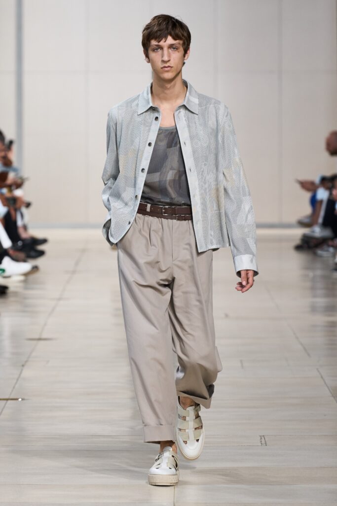 A relaxed gray cotton long-sleeve collared shirt paired with beige wide-leg pants.