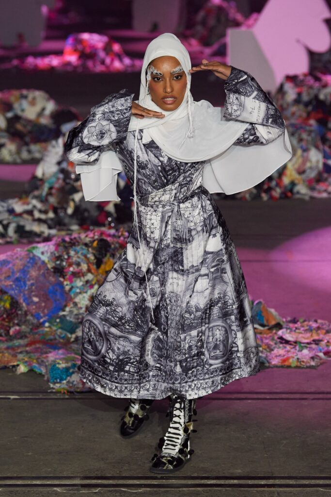 A relaxed black and white printed dress with long sleeves and a collared neckline.