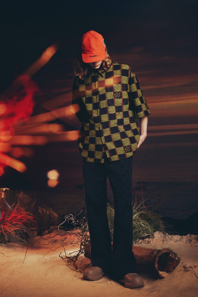 A relaxed-fit green checked short-sleeve shirt paired with black pants.