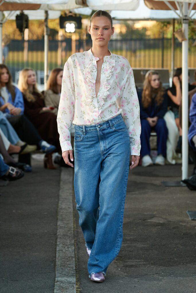 A relaxed floral long-sleeve shirt paired with wide-leg denim jeans.