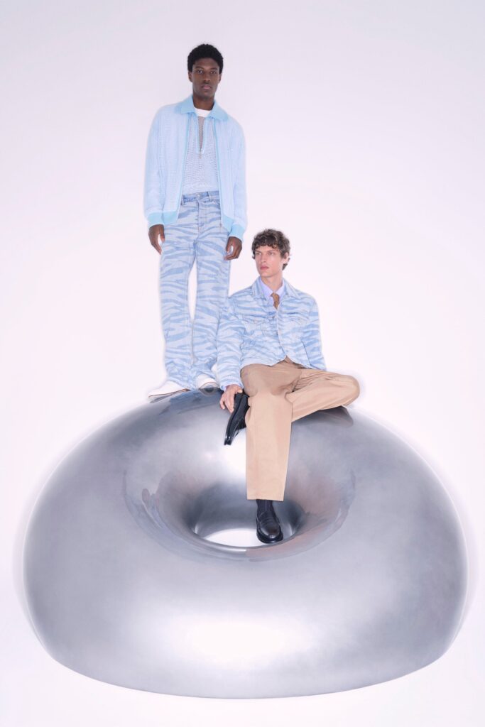 A relaxed blue striped jacket paired with beige pants, featuring a long-sleeve and collared design.