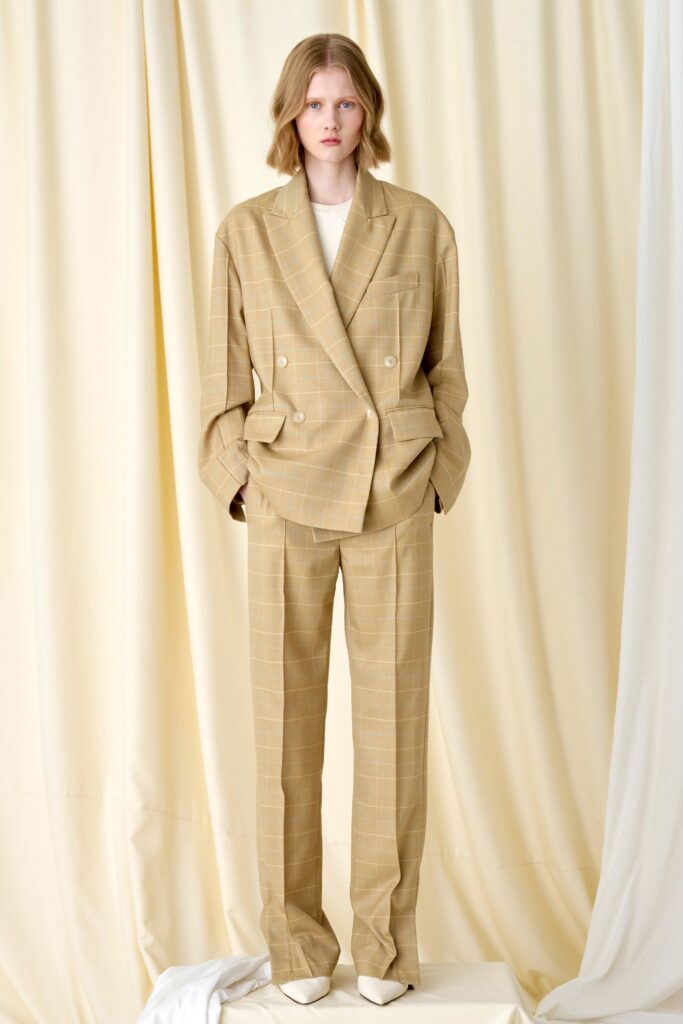 A relaxed beige checked suit with long sleeves and a collared design.
