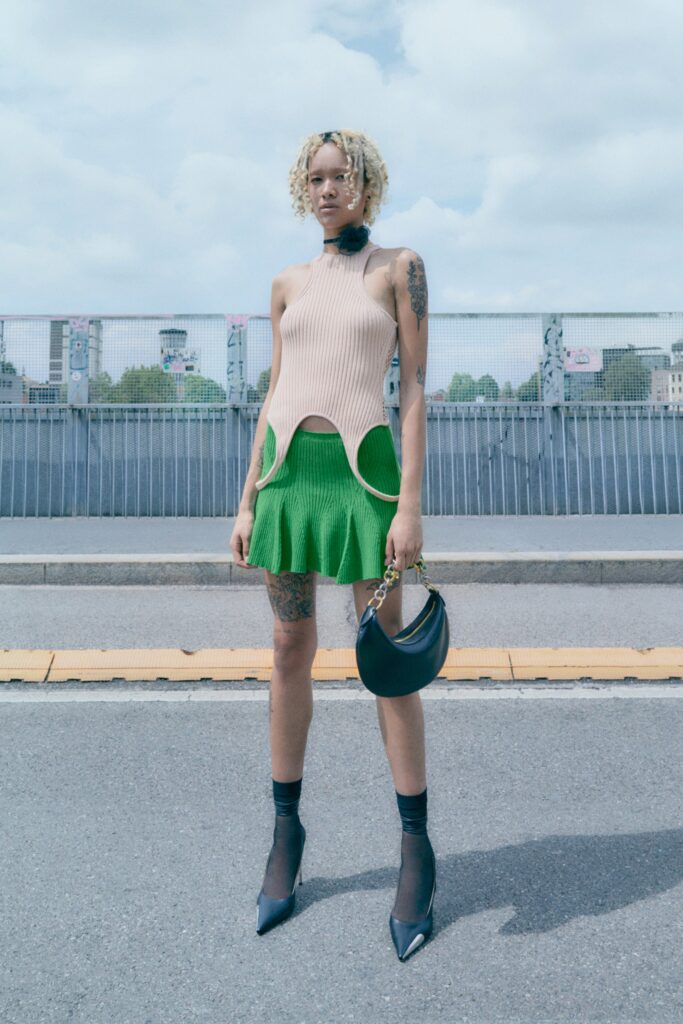 beige fitted top with green mini skirt