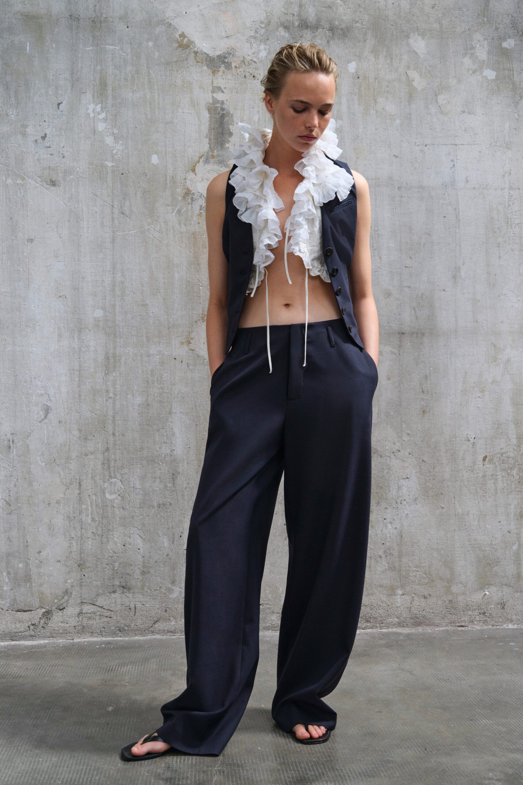 black fitted vest and relaxed pants
