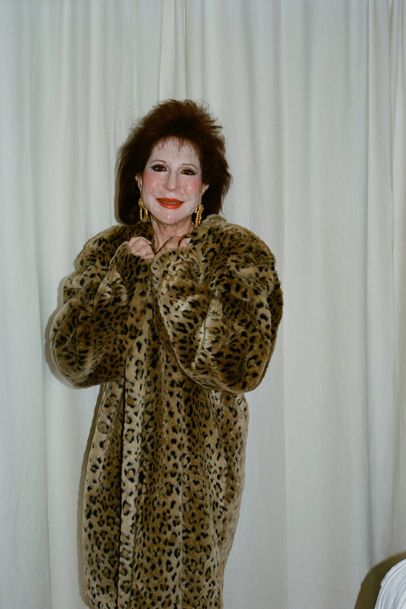 An oversized brown fur coat featuring an animal-print design and long sleeves.