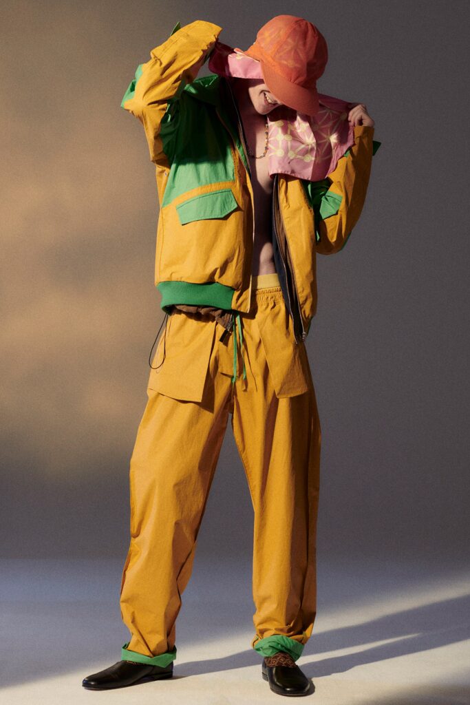 A relaxed fit orange and green jacket paired with matching pants, featuring a zippered design.