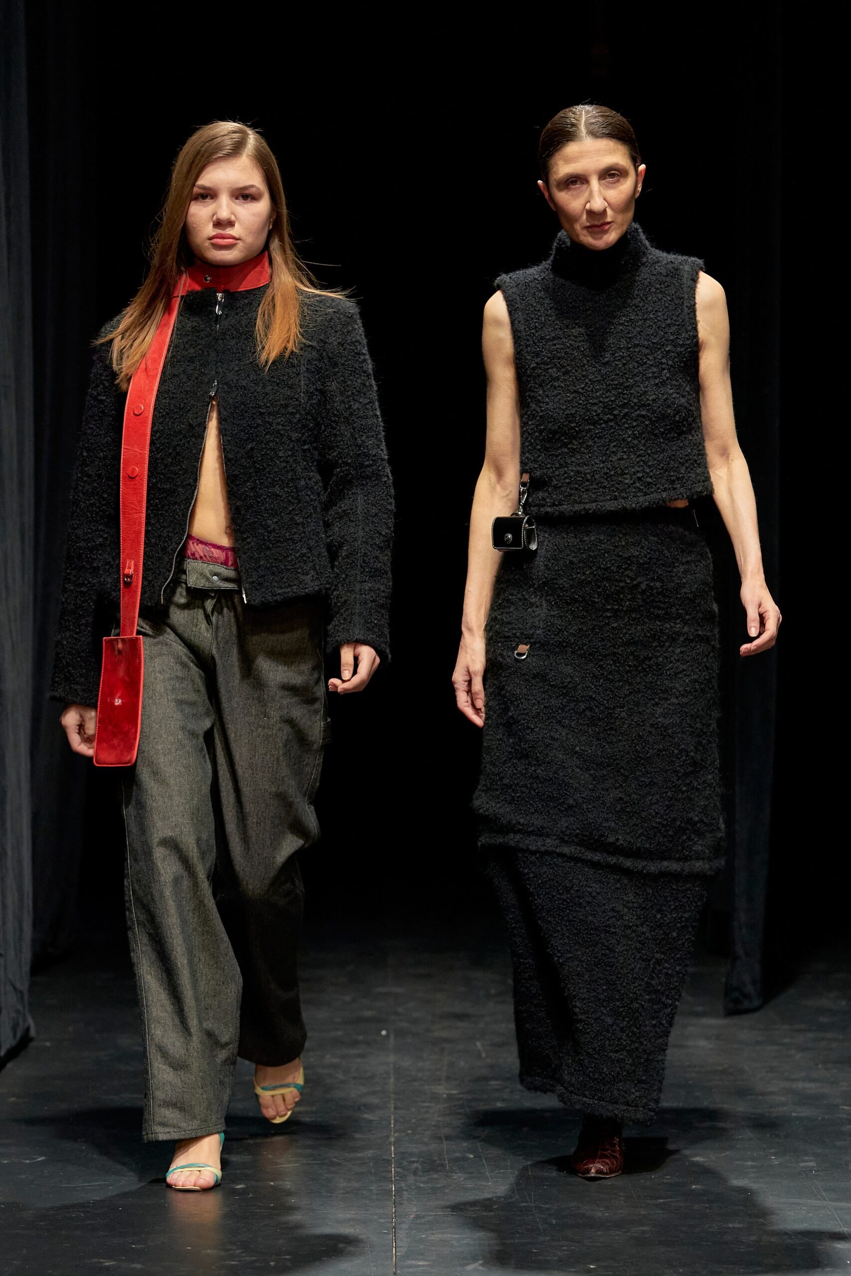 A fitted black wool sleeveless dress with a high neckline and straight-leg silhouette.