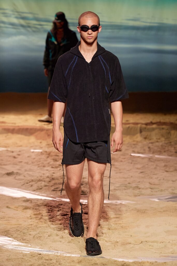 A relaxed black cotton hoodie with short sleeves paired with matching shorts.