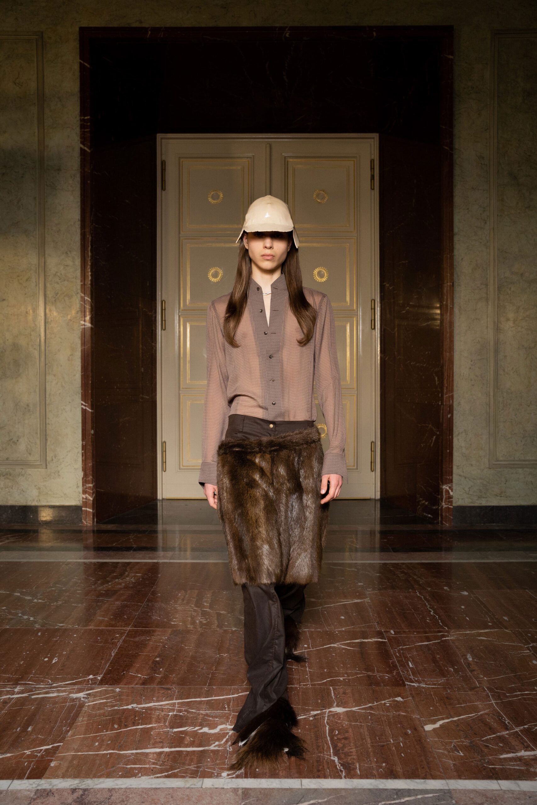 A fitted brown cotton shirt with long sleeves paired with straight-leg pants.