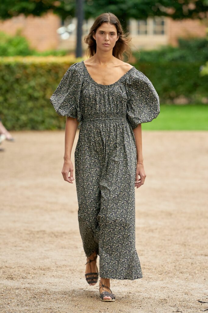 A relaxed black cotton dress with short sleeves and a flared silhouette.
