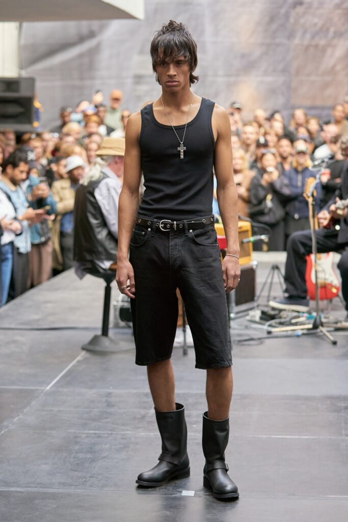 A fitted black tank-top paired with high-waisted black denim shorts, creating a stylish summer look.