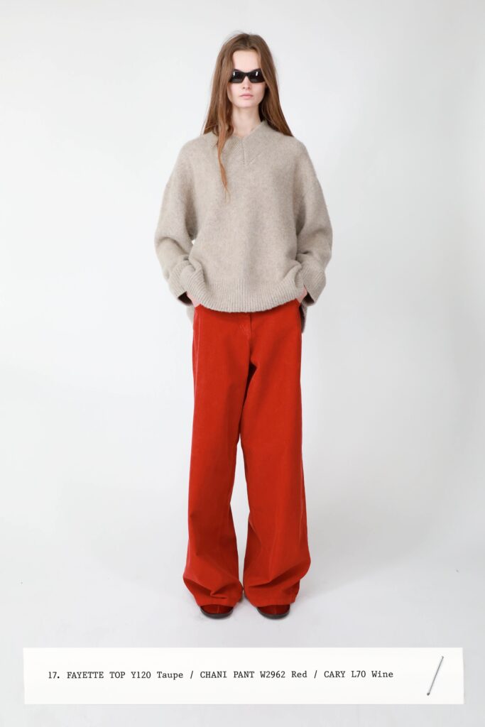 A relaxed taupe wool long-sleeve top paired with wide-leg red pants.