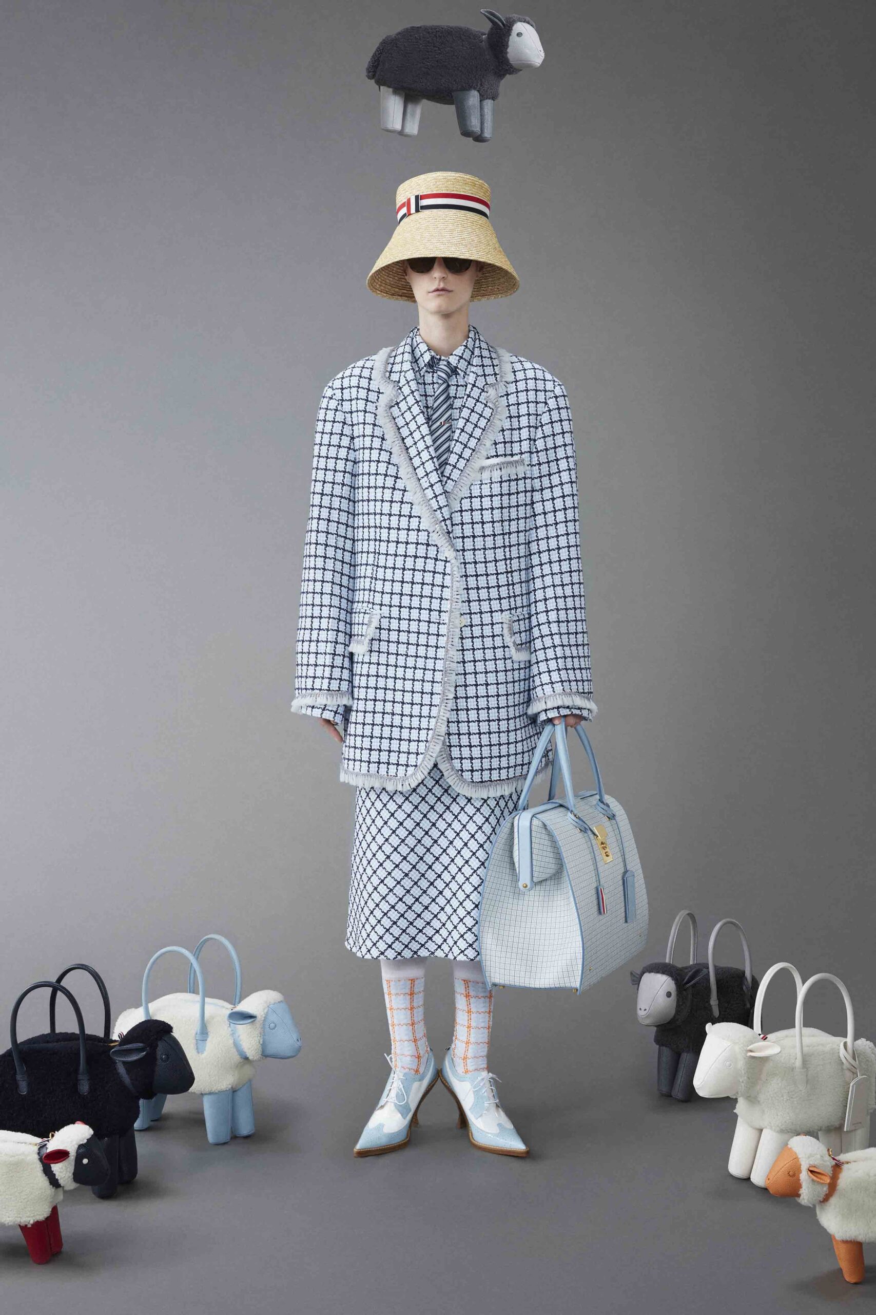 A tailored blue and white checked suit with a collared long-sleeve shirt and matching skirt.
