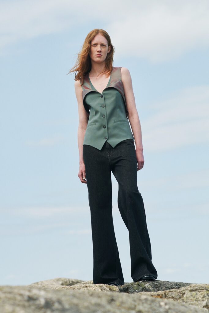 fitted green sleeveless top and relaxed black pants