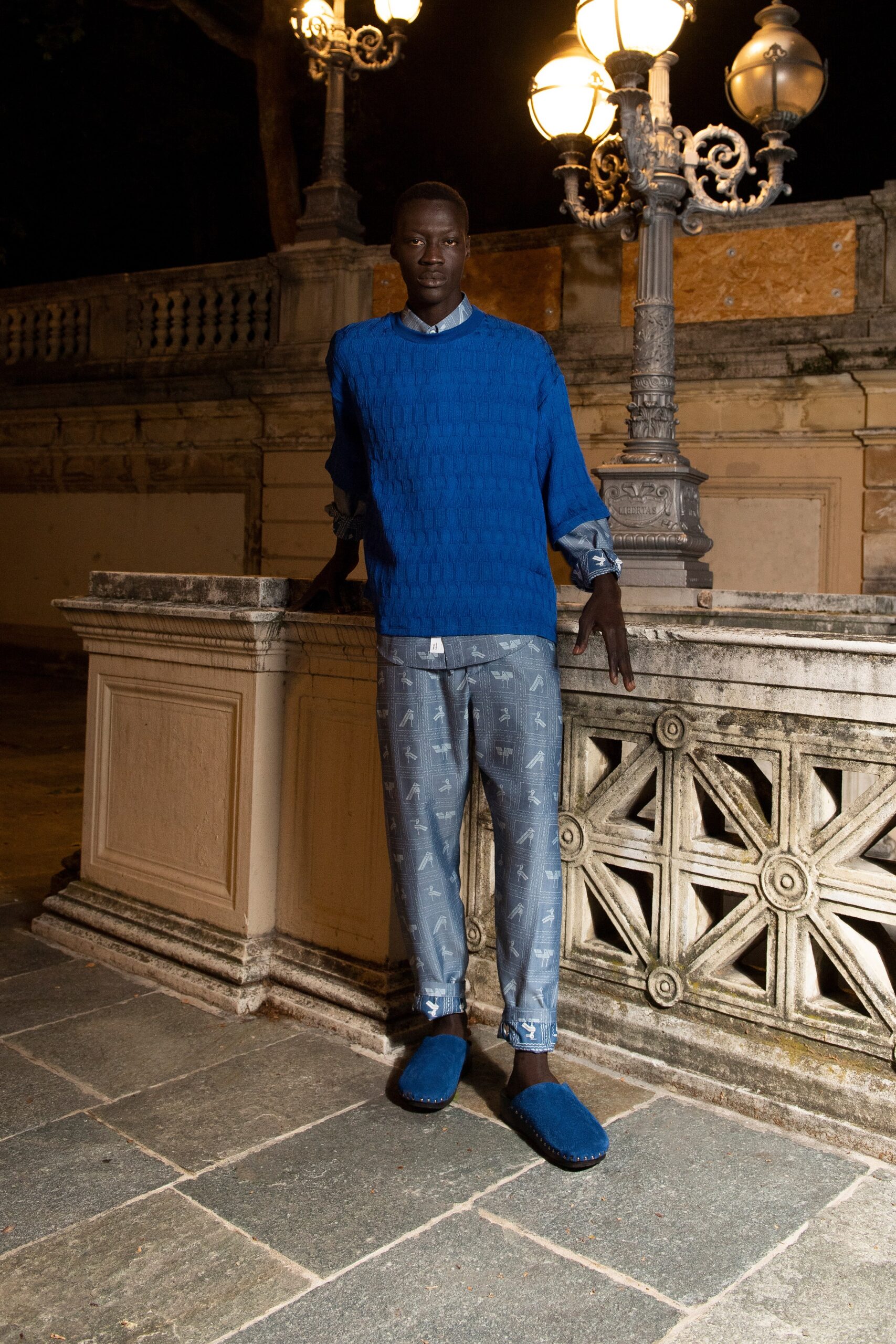 A relaxed blue cotton sweater with long sleeves paired with printed pants.