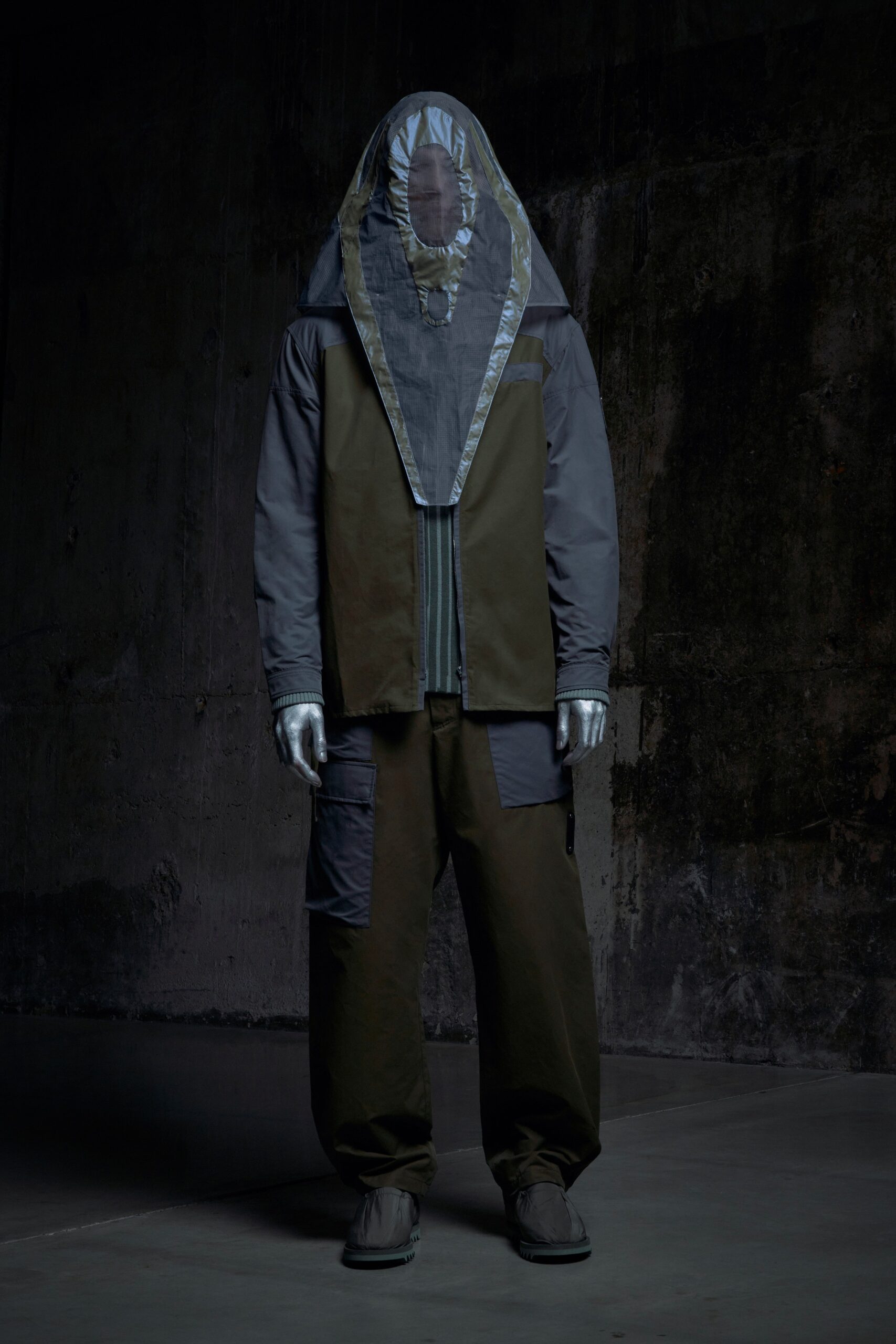 A relaxed black and green jacket with long sleeves and layered design, paired with matching pants.