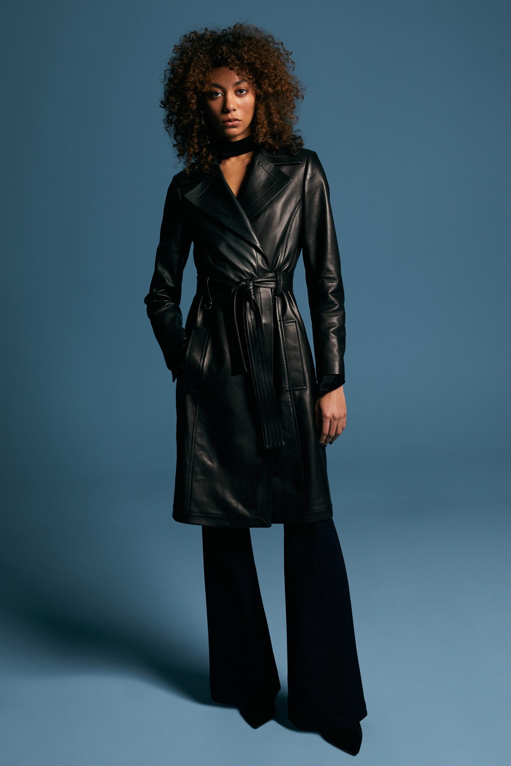 black leather coat and flared pants