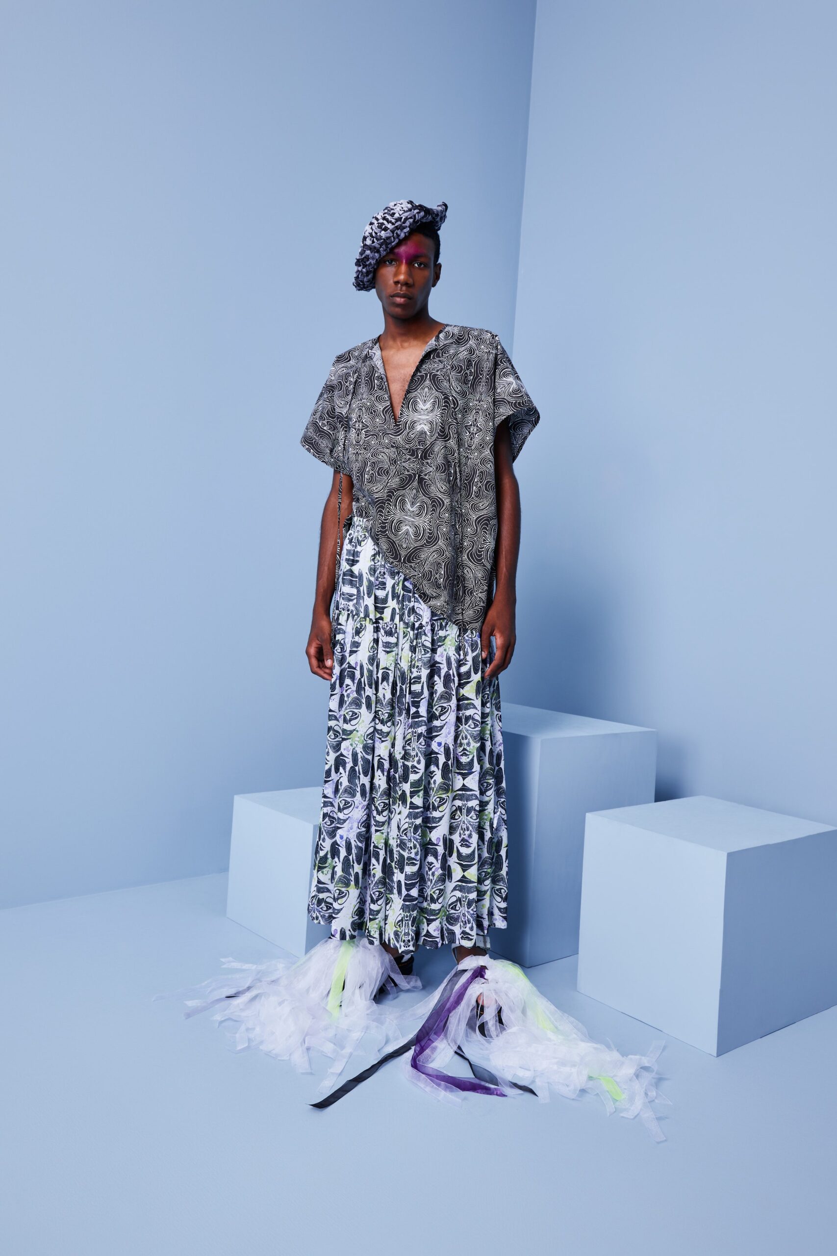 This relaxed dress features a striking black and white print that captures attention with its intricate patterns. The tiered design adds depth and movement, while the short sleeves and V-neckline enhance its effortless silhouette.