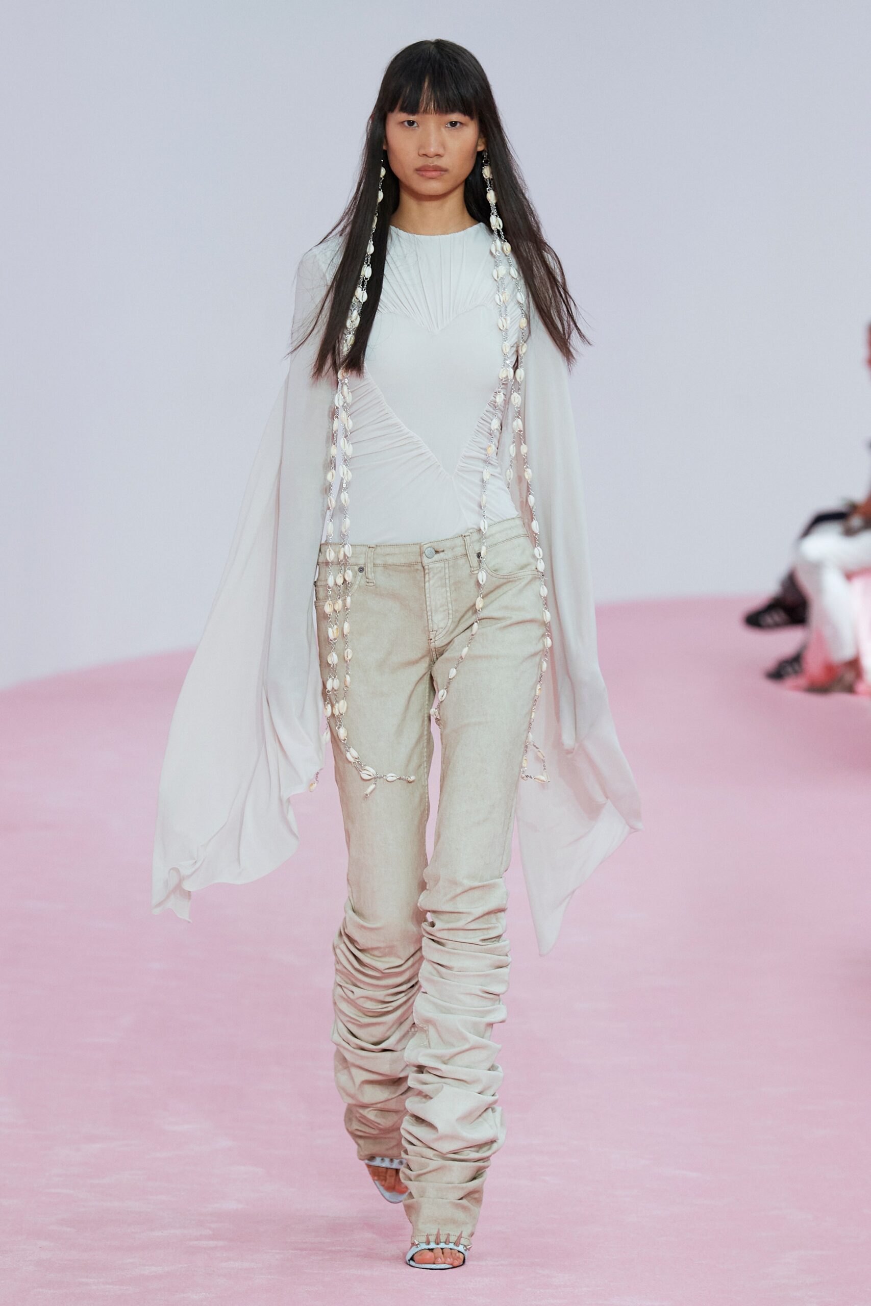 white fitted top with draped beige pants