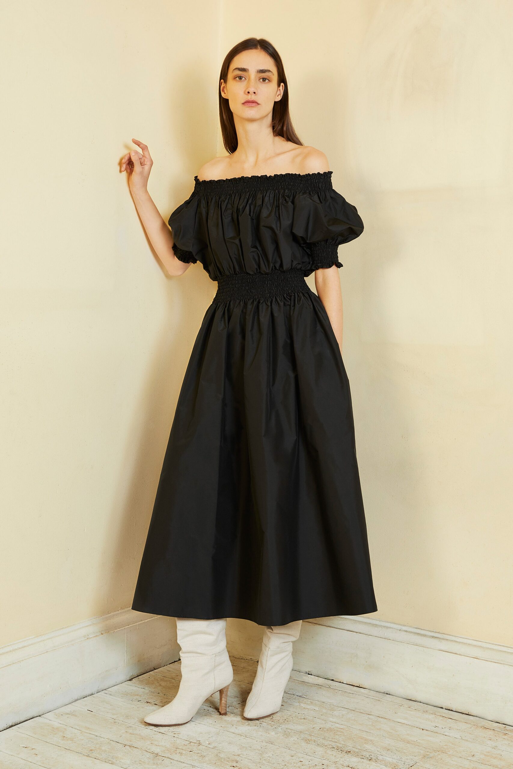 black off-shoulder midi dress with white boots
