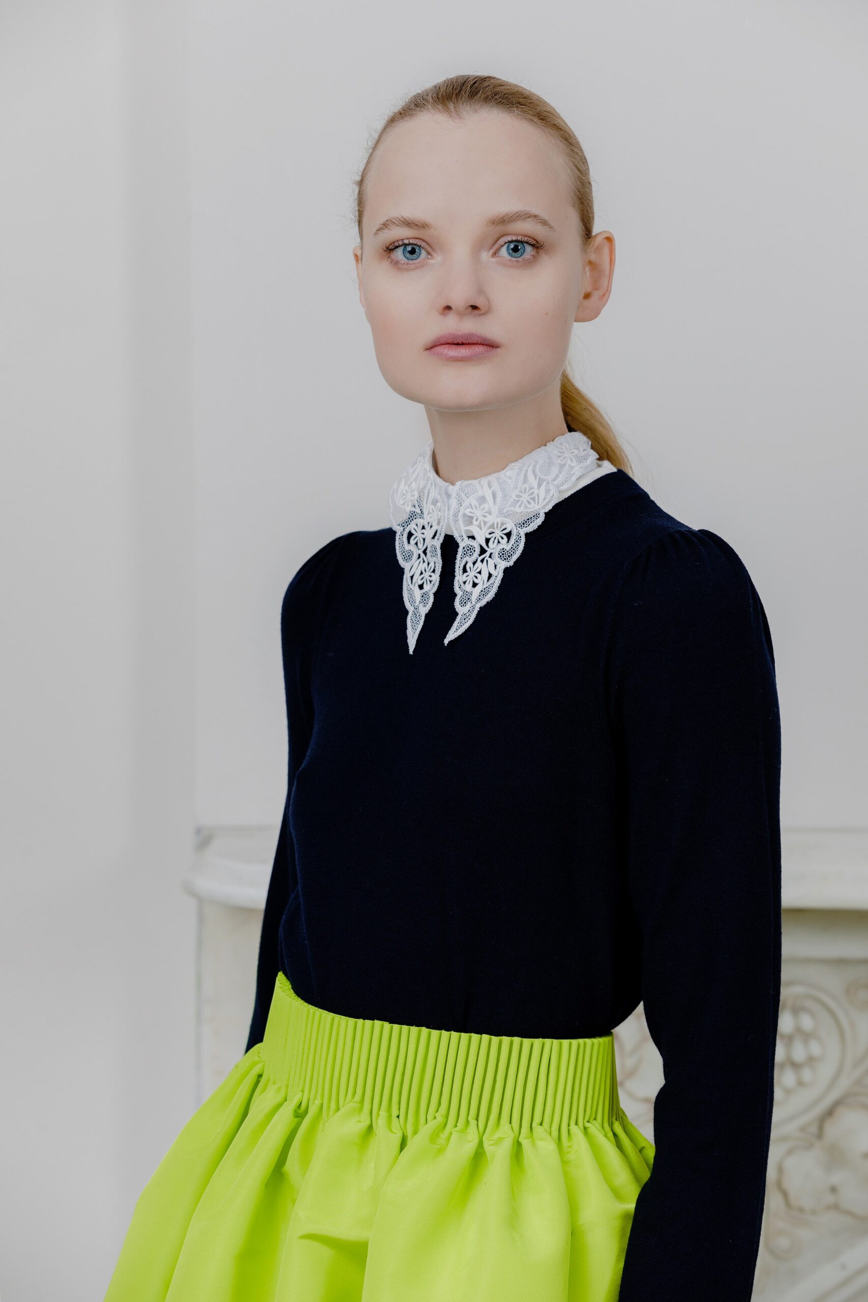 navy top with pleated neon green skirt