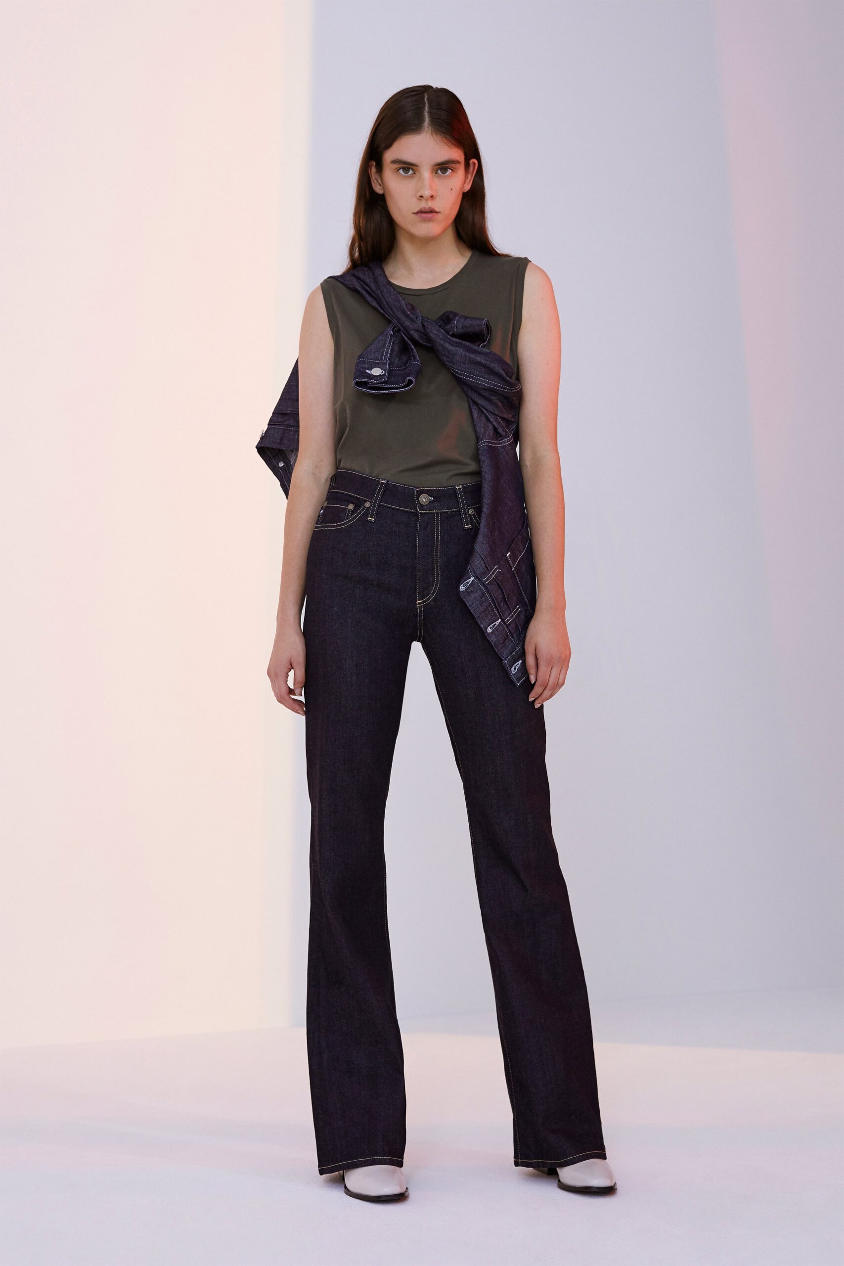 green fitted top with flared jeans