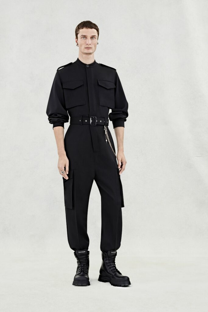A fitted black cotton jumpsuit with long sleeves and a zippered front.