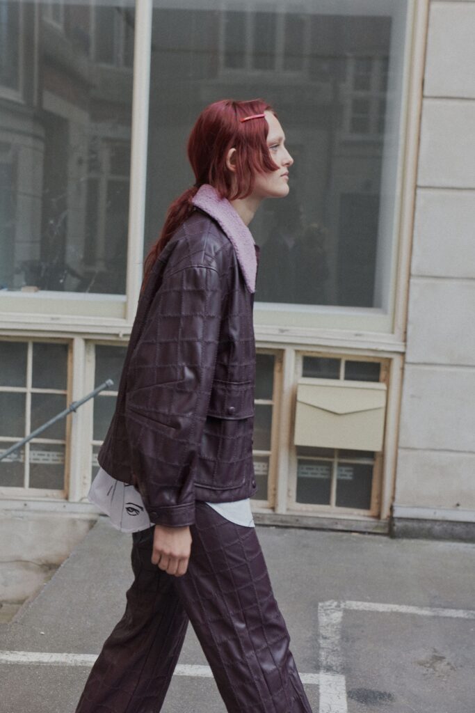 A relaxed-fit purple leather quilted jacket paired with matching pants for a stylish look.
