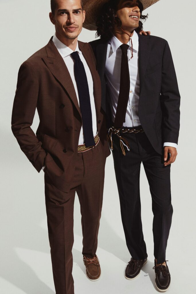 A tailored brown and black suit with long sleeves and buttoned details.