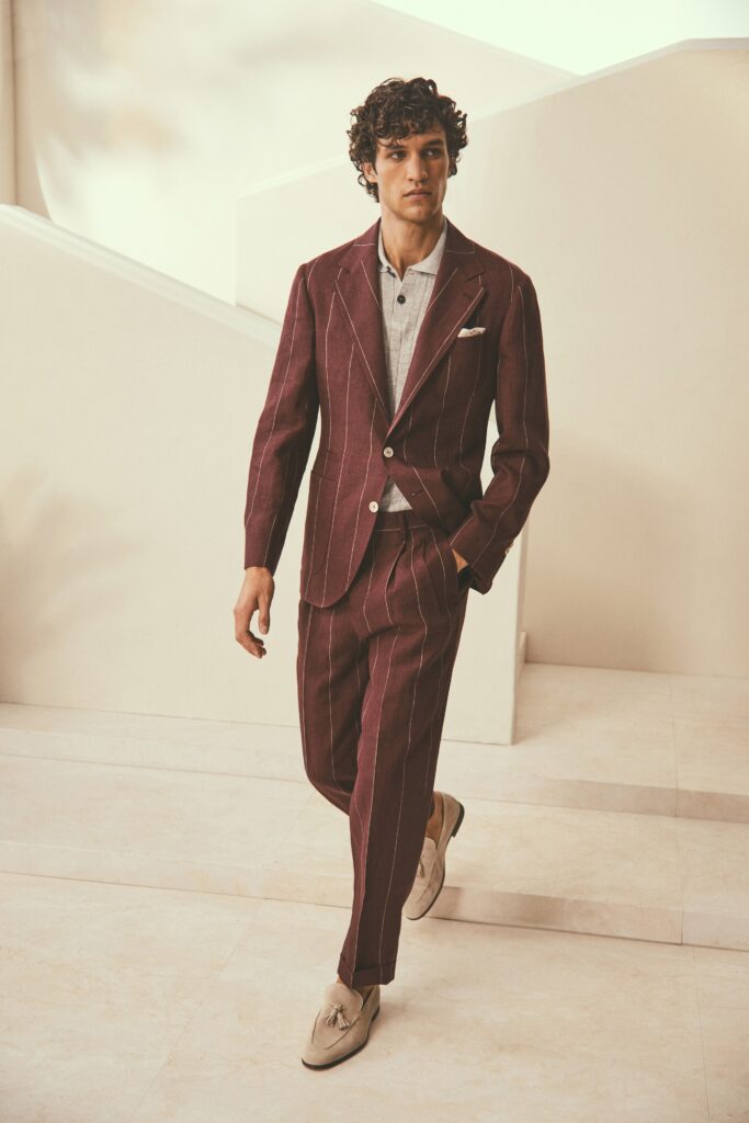 A tailored burgundy striped suit with a long-sleeve collared shirt.