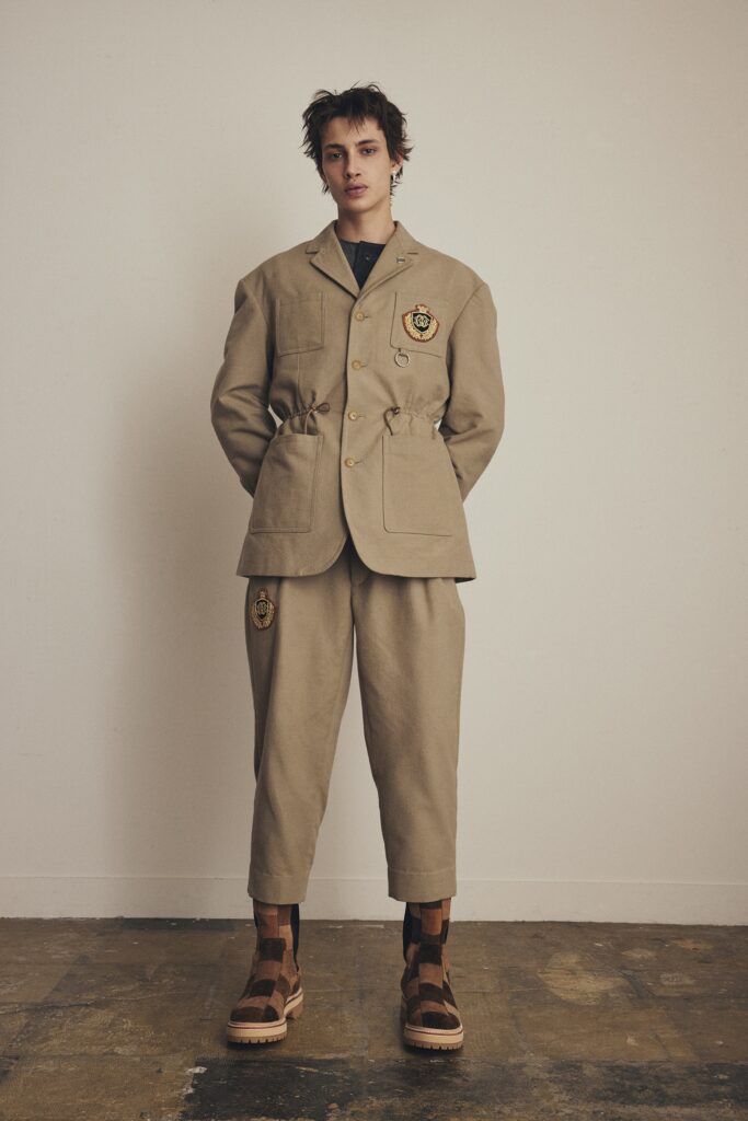 A relaxed beige cotton jacket with long sleeves and collared design paired with matching pants.