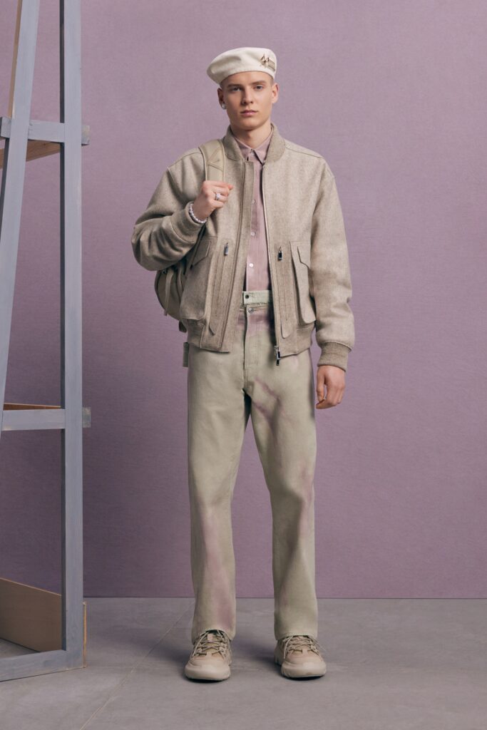 An oversized beige jacket paired with fitted gray pants, creating a stylish casual look.