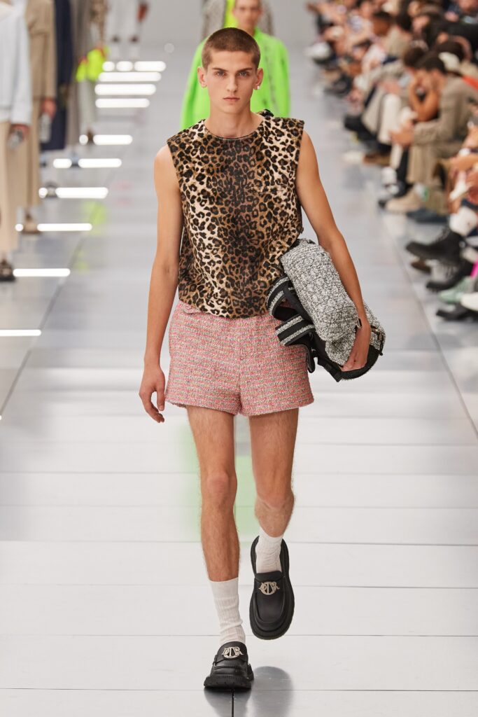 A fitted brown animal-print sleeveless top paired with pink flared shorts.