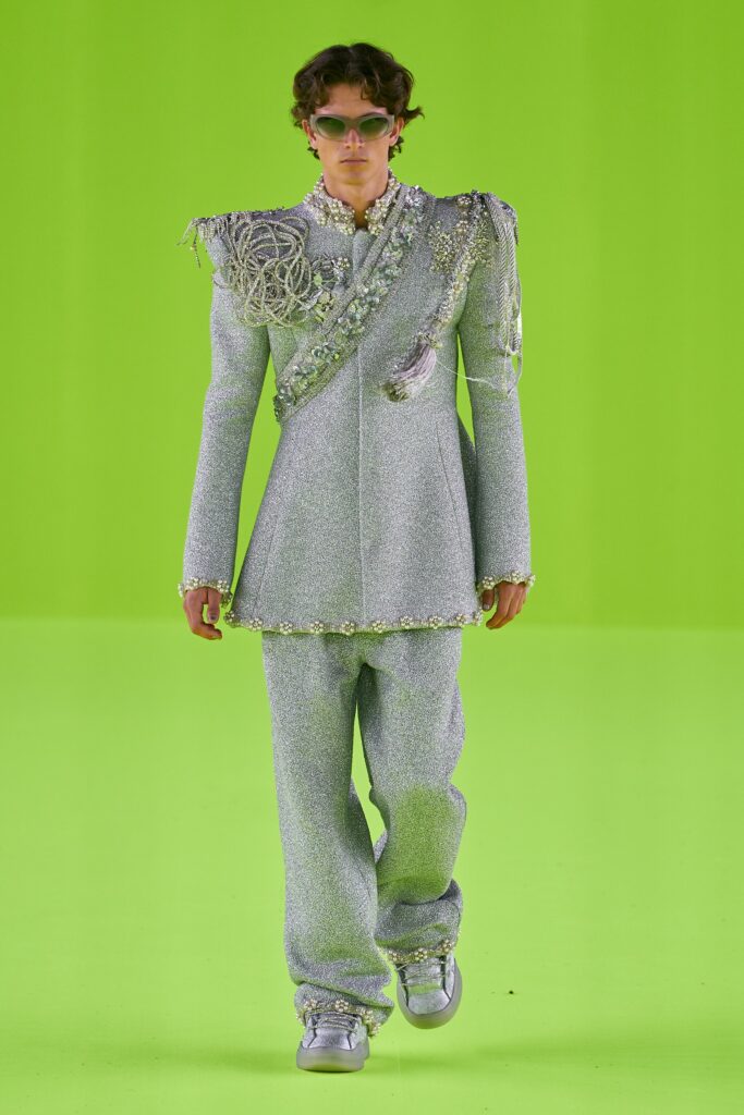 A tailored silver metallic suit with long sleeves and embroidered details.