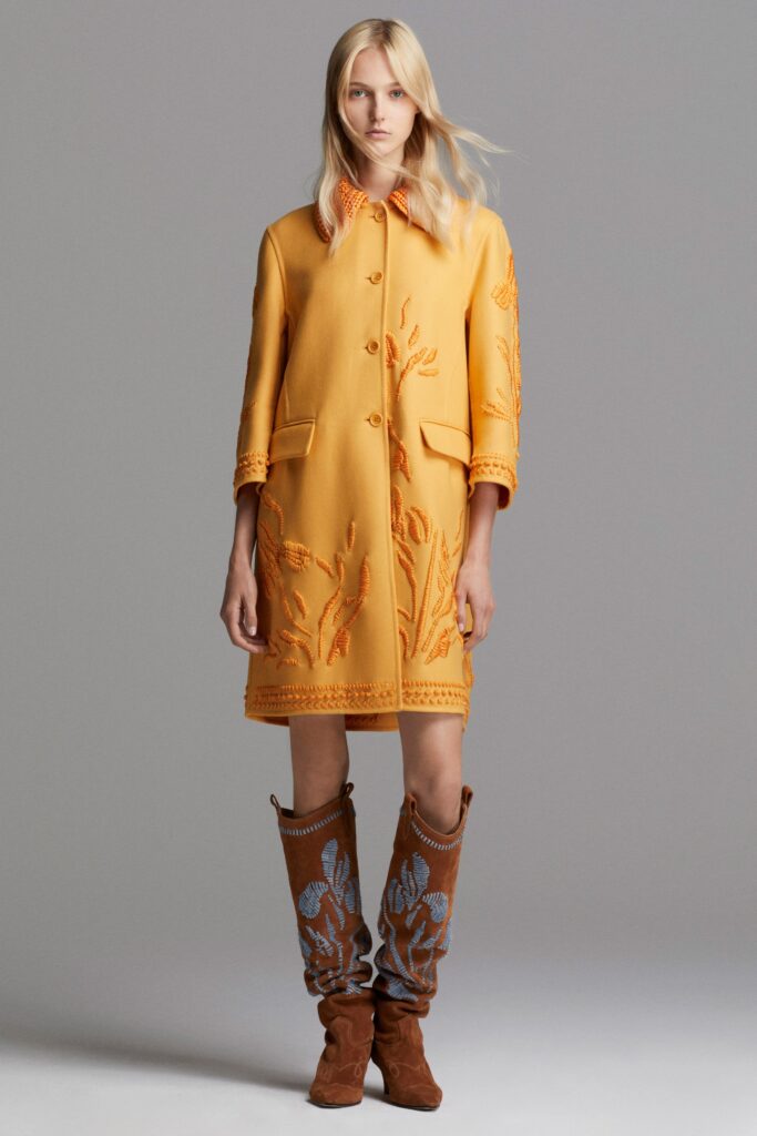 yellow embroidered coat and brown boots