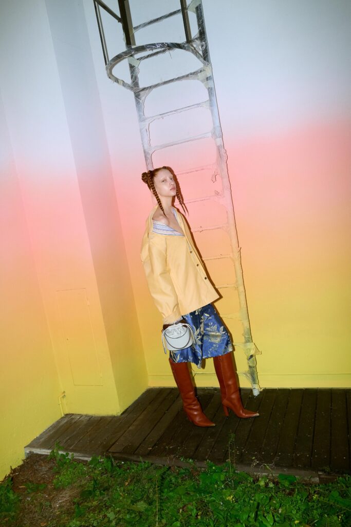A relaxed yellow jacket paired with printed blue denim pants for a stylish look.
