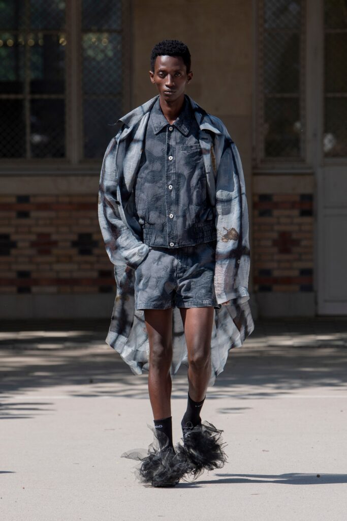 A relaxed fit gray cotton jacket with long sleeves and a collared design, paired with matching shorts.