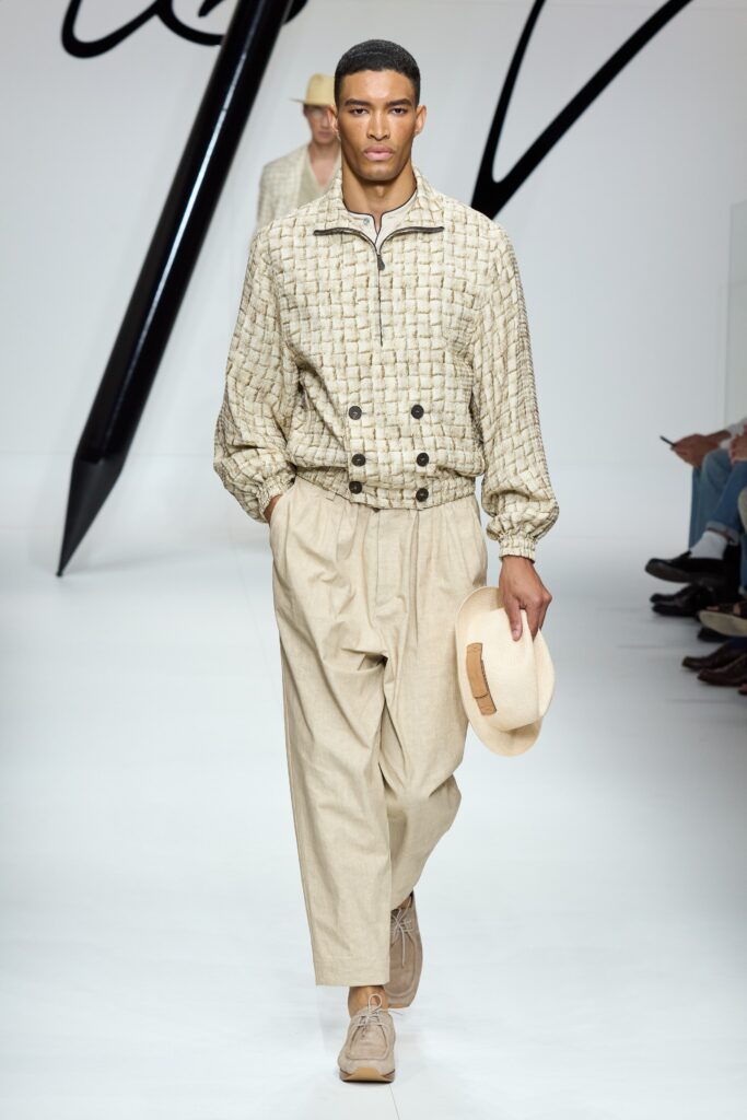 A relaxed beige cotton jacket with a collared neckline and wide-leg pants.