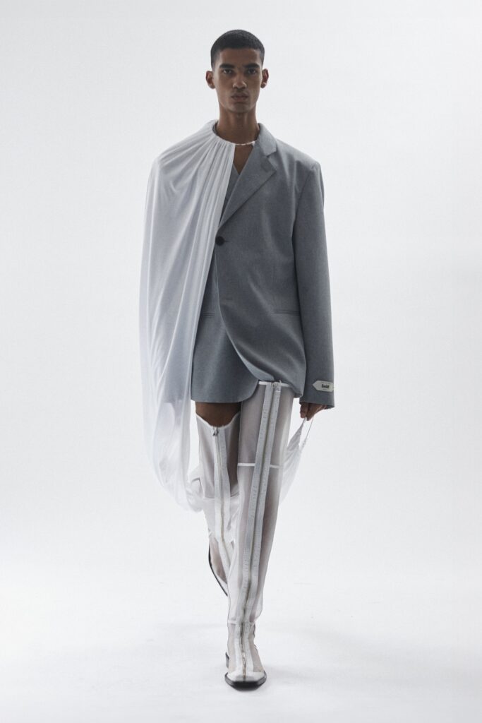 An oversized gray jacket dress with long sleeves and an asymmetric design detail.