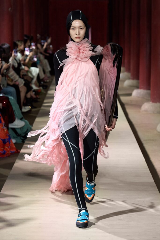 pink draped midi dress with black catsuit