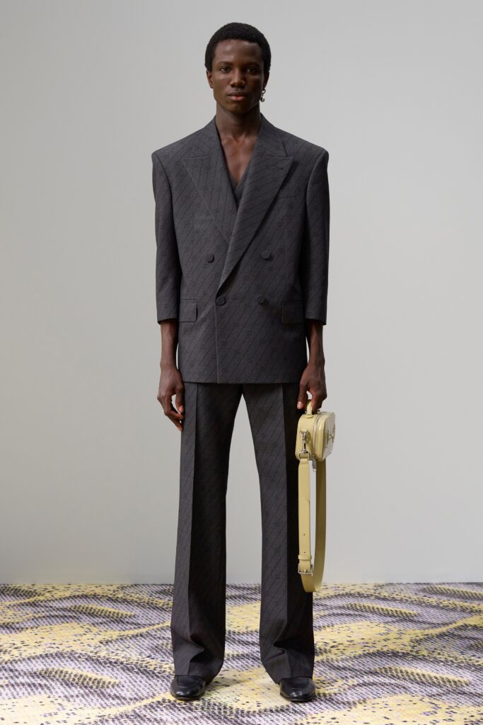 A tailored black suit with long sleeves, a collared neckline, and wide-leg trousers.
