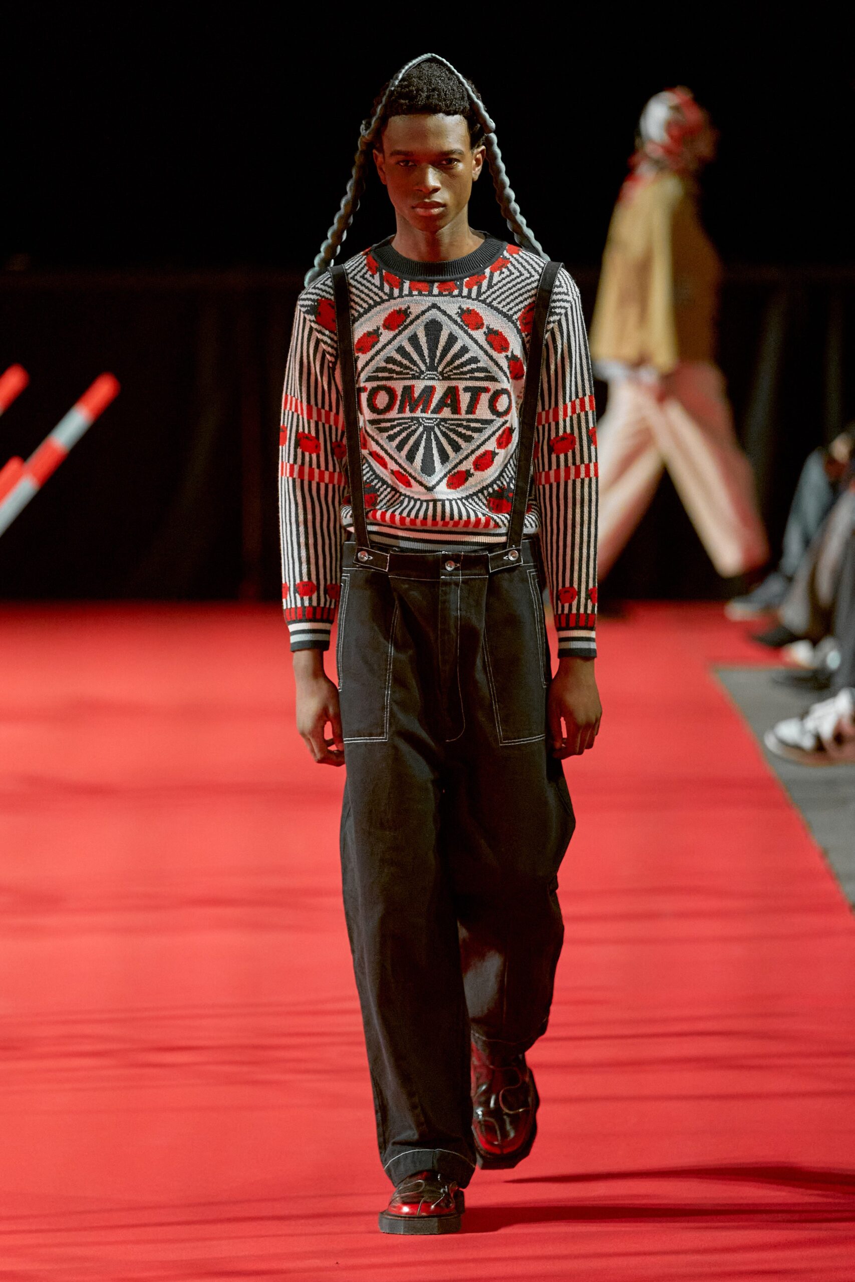 A relaxed fit outfit featuring black pants and a long-sleeve printed shirt with a bold design.
